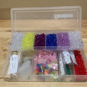 beads lot in plastic organizer. Includes some plastic elastic thread and clasps